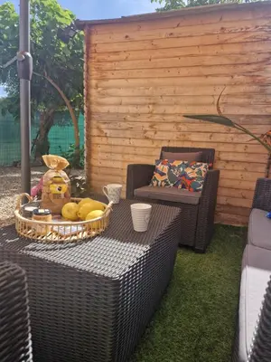 a wicker table with a basket of fruit on it at Maison pour 4 personnes en bord de mer in Borgo