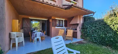 a patio with a table and chairs in a house at ORO 3-Piscine en résidence- Tennis-Wifi in Conca