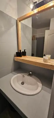 a bathroom with a white sink and a mirror at ORO 3-Piscine en résidence- Tennis-Wifi in Conca
