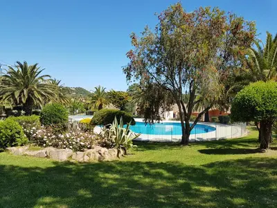 a swimming pool in a park with trees and a yard at ORO 3-Piscine en résidence- Tennis-Wifi in Conca