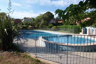 a fence around a swimming pool in a yard at ORO 3-Piscine en résidence- Tennis-Wifi in Conca