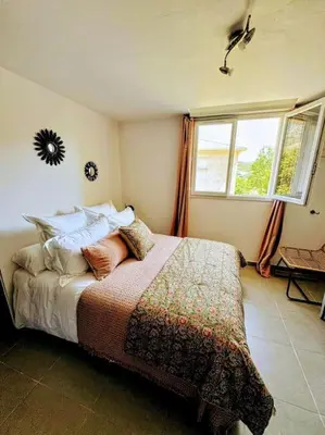 a bedroom with a bed with pillows and a window at Casa Carlu Maria III in Corte