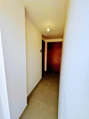 an empty hallway with a door and a tile floor at Casa Carlu Maria III in Corte