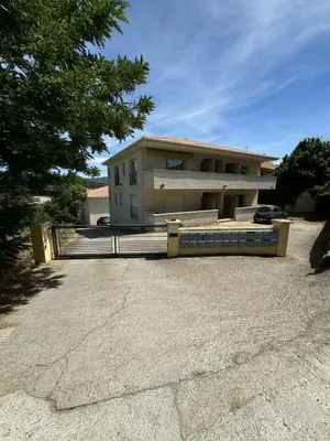 a building with a fence in front of it at Casa Carlu Maria III in Corte