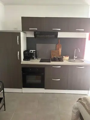 a kitchen with a sink and a counter top at Casa Carlu Maria II in Corte