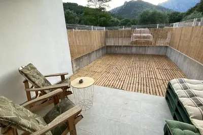 a patio with two chairs and a basketball hoop at Casa Carlu Maria II in Corte