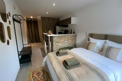 a hotel room with a bed and a kitchen at Casa Carlu Maria I in Corte