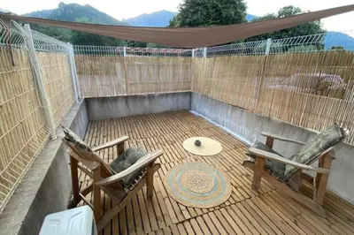 a patio with two chairs and a table and a hammock at Casa Carlu Maria I in Corte