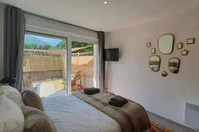 a bedroom with a bed and a large window at Casa Carlu Maria I in Corte
