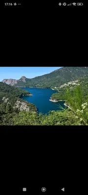 a view of a lake in two different pictures at Studio à la campagne in Ocana
