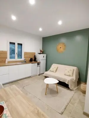 a kitchen with a bed and a table in a room at Studio à la campagne in Ocana