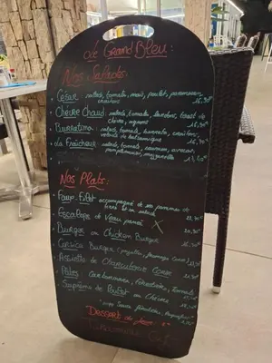 a chalkboard sign with a menu for a restaurant at Les pieds dans l'eau in San-Nicolao