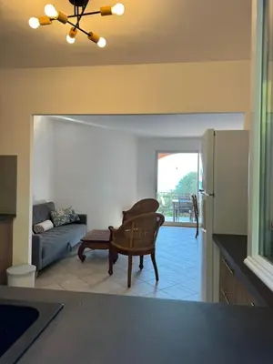a living room with a couch and a chair at villa arbutu in Olmeto