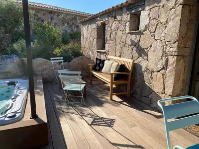 a wooden deck with a bench and a tub at Les Bergeries de Pinarello, Capellina in Zonza