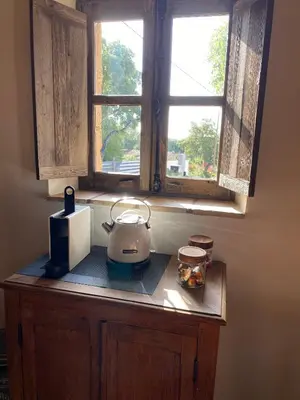 a kitchen counter with a blender and a window at Les Bergeries de Pinarello, Capellina in Zonza