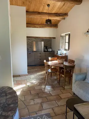 a kitchen and dining room with a table and chairs at Les Bergeries de Pinarello, Capellina in Zonza
