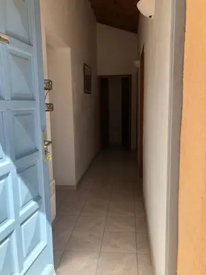 an empty hallway with a door and a tile floor at Villa acula in Olmeto