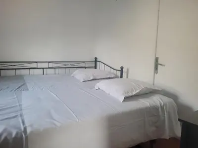 a white bed with two pillows on top of it at La maison de corse in Feliceto