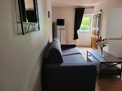 a living room with a couch and a table at La maison de corse in Feliceto