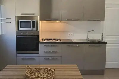 a kitchen with a microwave and a stove and a sink at Casa Figarella in Calenzana