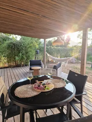 a table with a plate of food and glasses of wine at Casa Figarella in Calenzana