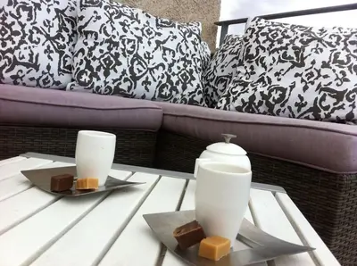 a coffee table with two white vases on top at Villa Pieds dans l eau in Porto-Vecchio