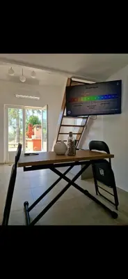a desk in a room with a staircase at Appartement a 5min de la plage in Penta-di-Casinca