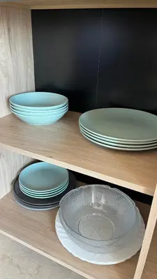 a shelf filled with plates and bowls at Le plein soleil in Ajaccio