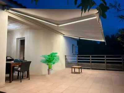 a patio with a table and a potted plant at La Belle-Hélène - Proche plage, 30 min d'ajaccio in Albitreccia