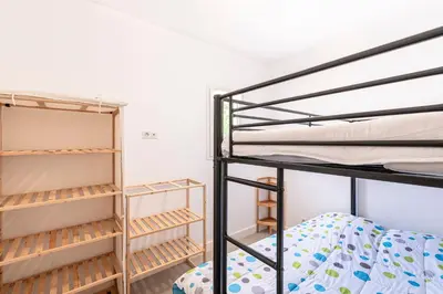 a room with two bunk beds and shelves at La Belle-Hélène - Proche plage, 30 min d'ajaccio in Albitreccia
