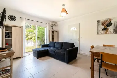 a living room with a couch and a table at La Belle-Hélène - Proche plage, 30 min d'ajaccio in Albitreccia