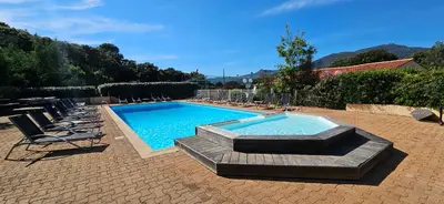 a swimming pool with lounge chairs and a swimming poolvisor at T2 Résidence Dolce & Vita C4 vue mer et piscine in Propriano
