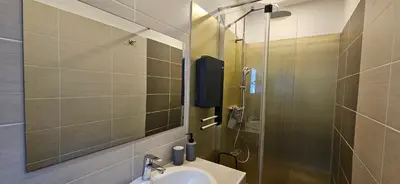 a bathroom with a sink and a shower at T2 Résidence Dolce & Vita C4 vue mer et piscine in Propriano