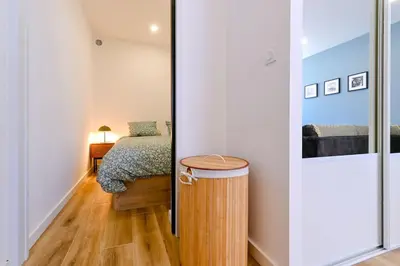 a small bedroom with a bed and a table at Studio Cosy à Ajaccio in Ajaccio