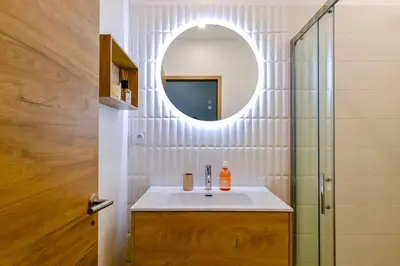 a bathroom with a sink and a mirror at Studio Cosy à Ajaccio in Ajaccio