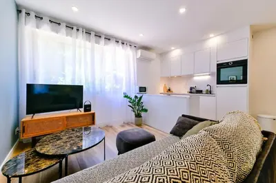a living room with a couch and a tv at Studio Cosy à Ajaccio in Ajaccio