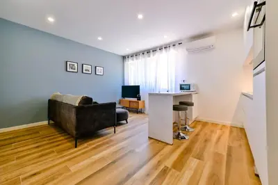 a living room with a couch and a table at Studio Cosy à Ajaccio in Ajaccio