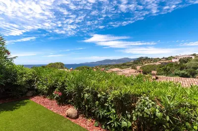 a garden with a view of the ocean at Libertà - Appt à porticcio climatisé proche plage in Grosseto-Prugna