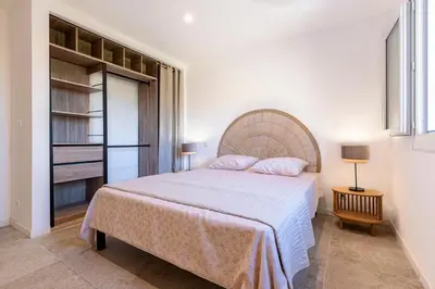 a bedroom with a large bed and a closet at Libertà - Appt à porticcio climatisé proche plage in Grosseto-Prugna