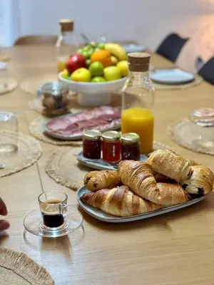 a table topped with a plate of pastries and fruit at Bella Vita in Calenzana