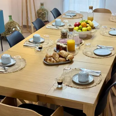 a long wooden table with plates of food on it at Bella Vita in Calenzana