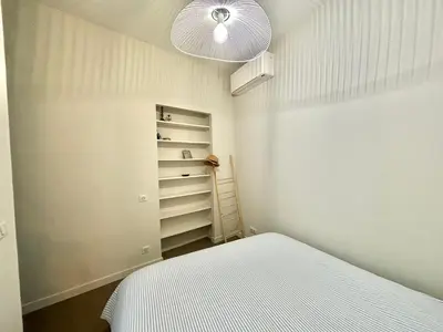 a small bedroom with a bed and a closet at Appartement studio cours napoleon Ajaccio in Ajaccio