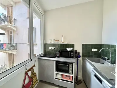a kitchen with a sink and a microwave at Appartement studio cours napoleon Ajaccio in Ajaccio