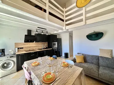 a living room with a table and a couch at Appartement 105 résidence Terra Bella 1 Porticcio in Porticcio