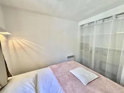 a white bedroom with a bed and a window at Appartement 105 résidence Terra Bella 1 Porticcio in Porticcio