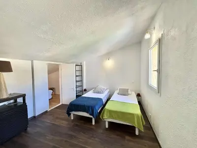 a small bedroom with a bed and a window at Appartement 105 résidence Terra Bella 1 Porticcio in Porticcio