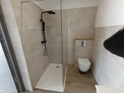 a bathroom with a glass shower with a toilet at Dume et Coco F2 55 M2 Vue mer in Taglio-Isolaccio