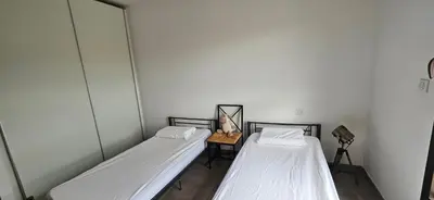 two beds in a small room with a table at T3 de standing Vigna Majo vue mer imprenable in Propriano