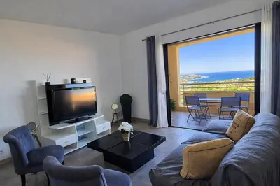 a living room with a couch and a tv at T3 de standing Vigna Majo vue mer imprenable in Propriano