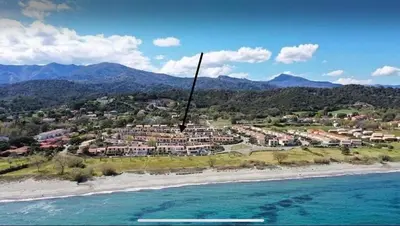 an aerial view of a resort on the beach at Maison a la plage in Poggio-Mezzana